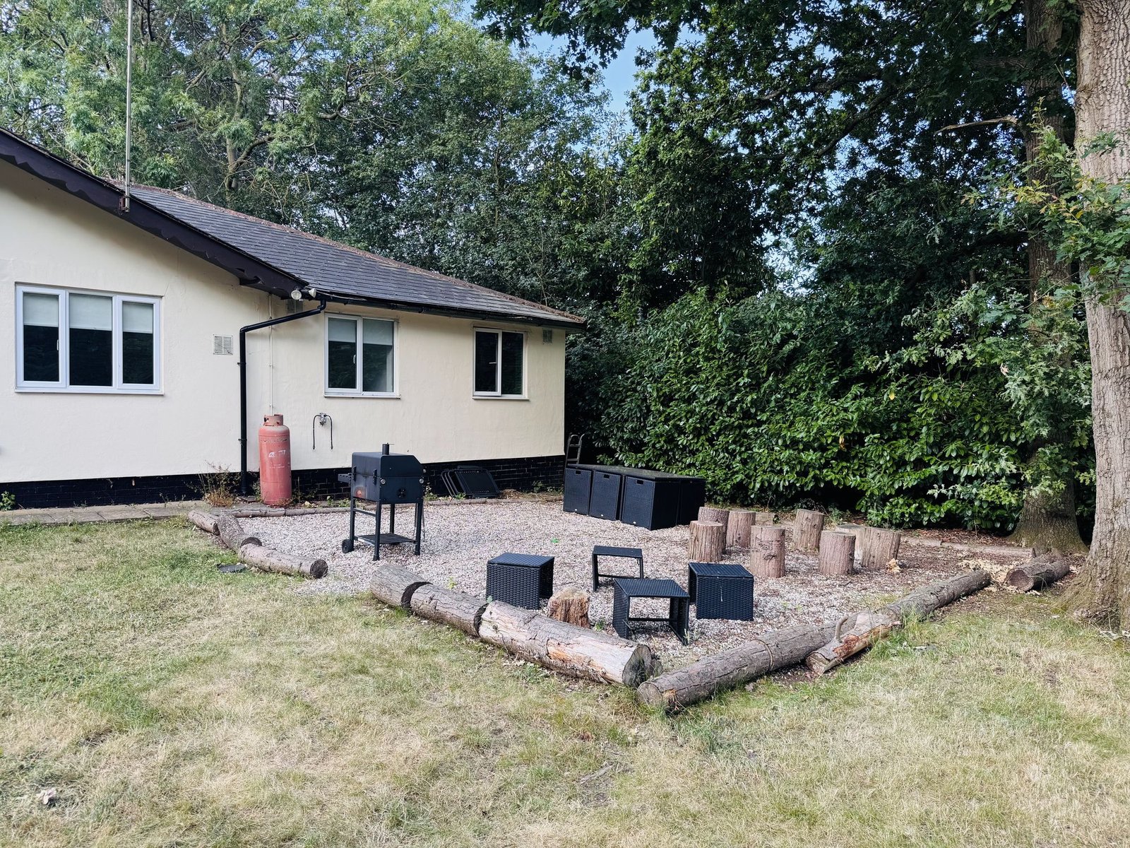 The Bungalow — outdoor fire pit and BBQ area